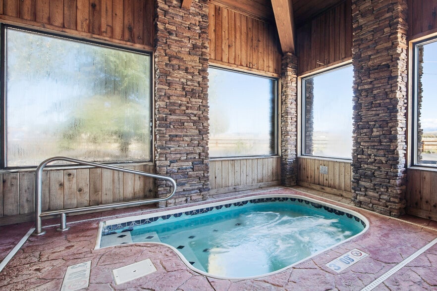 Indoor hot tub framed by stone columns