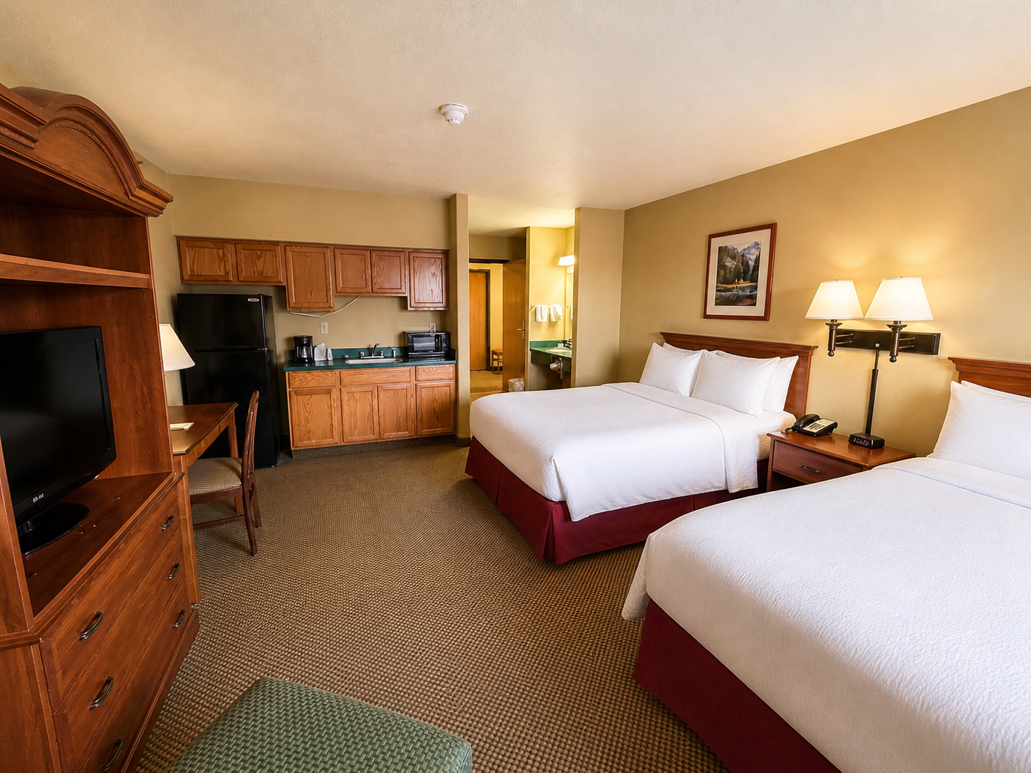 Deluxe 2 Double with full kitchen — two beds, fridge, microwave, and prep counter